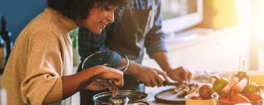 Two people cooking at home