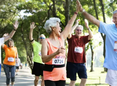 Groupd 70 year olds celebrating during a running race
