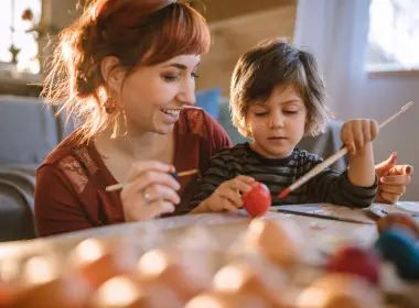Young woman and a boy painting and crafting