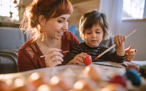 Young woman and a boy painting and crafting