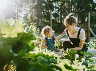 Young woman and small child gardening