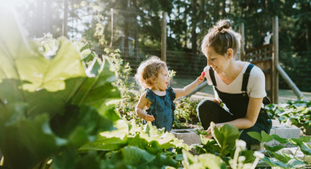 Young woman and small child gardening