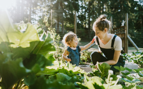 Young woman and small child gardening