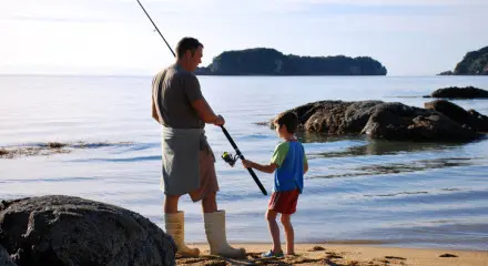Father and son fishing on the shore