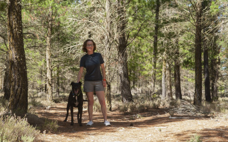 Ruth from the Happy Saver is pictured in a forest with a dog