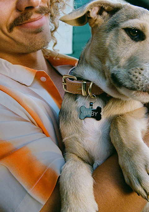 Man holding new baby (dog)