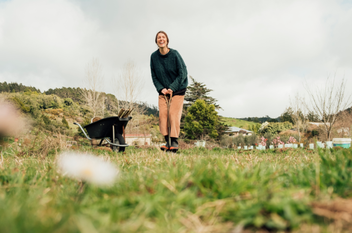 Woman standing next to a wheelbarrow
