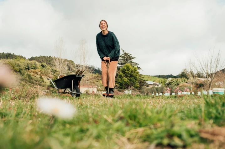 Woman standing next to a wheelbarrow