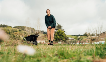 Woman standing next to a wheelbarrow