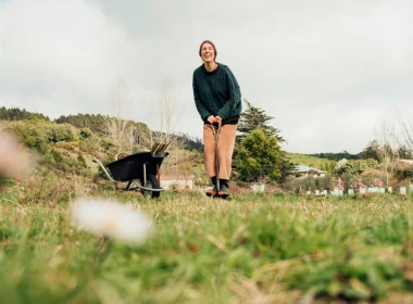 Woman standing next to a wheelbarrow