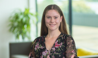 Sarah looking at camera smiling in an office