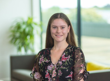 Sarah looking at camera smiling in an office