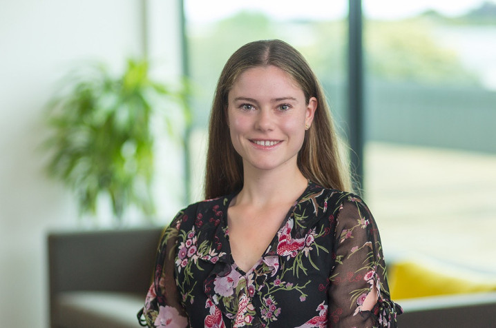 Sarah looking at camera smiling in an office