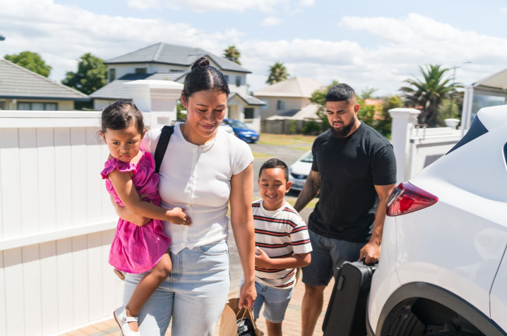 Family of four getting off a car thinking of their emergency savings.