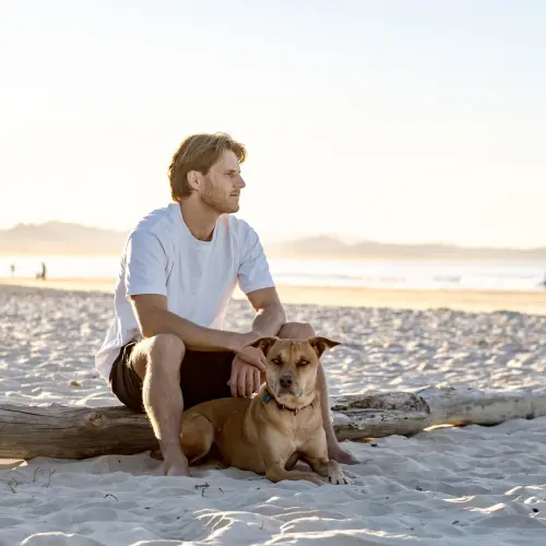 image manwithdogonbeach header