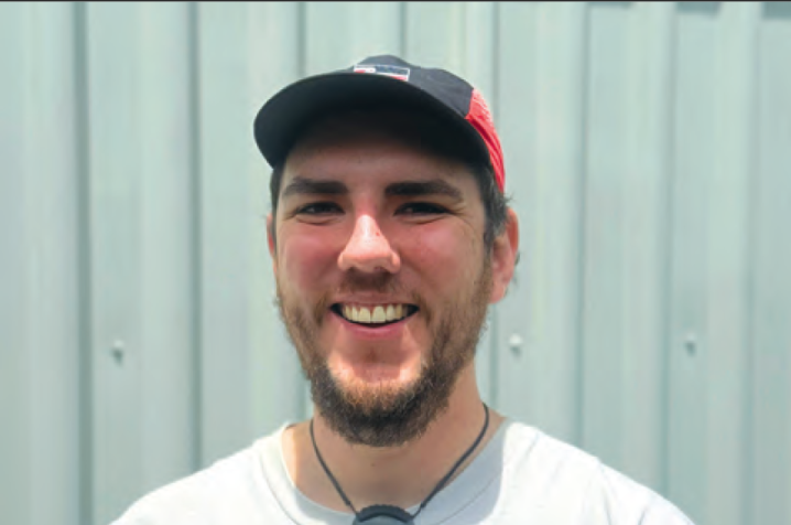 Tawera smiling looking at the camera wearing a cap