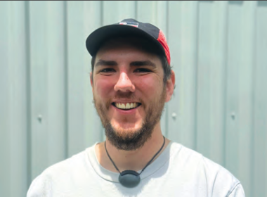 Tawera smiling looking at the camera wearing a cap