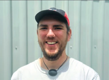 Tawera smiling looking at the camera wearing a cap